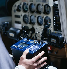 Pilot with ATS Radio Telemetry Receiver with integrated GPS used in cockpit of aerial wildlife tracking system aircraft